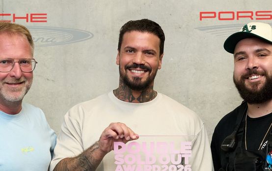 Gruppenfoto mit drei Personen, in der Mitte Emmvee, der den Award in den Händen hält. Links steht René Otterbein (in.Stuttgart Veranstaltungsgesellschaft), rechts Sascha Schmitz (Projektleiter Meyer-Konzerte).